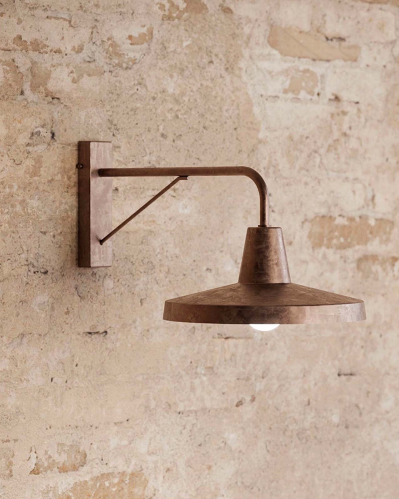 Officina wall light featuring a pre aged iron structure displayed on a brick wall