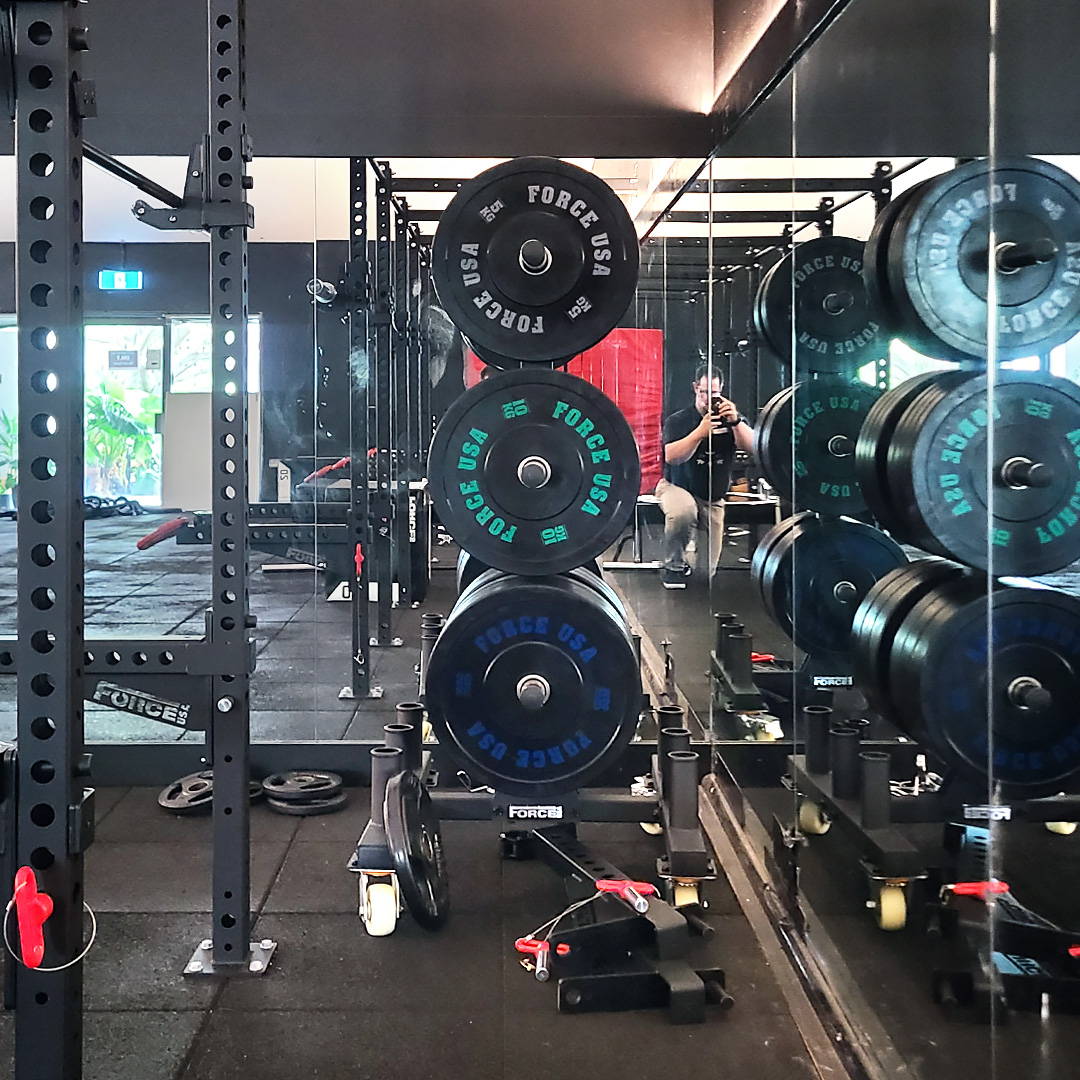 Premium commercial gym fit-out equipped with Force USA bumper plates and sturdy racks for intensive weightlifting