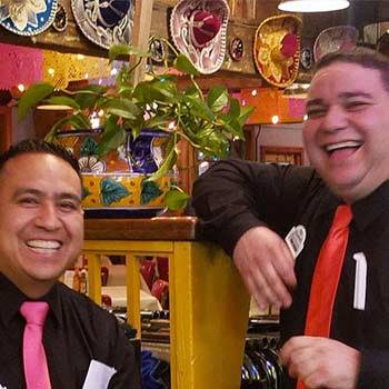 Customer spotlight at a mexican resturant waiters wearing colorful ties