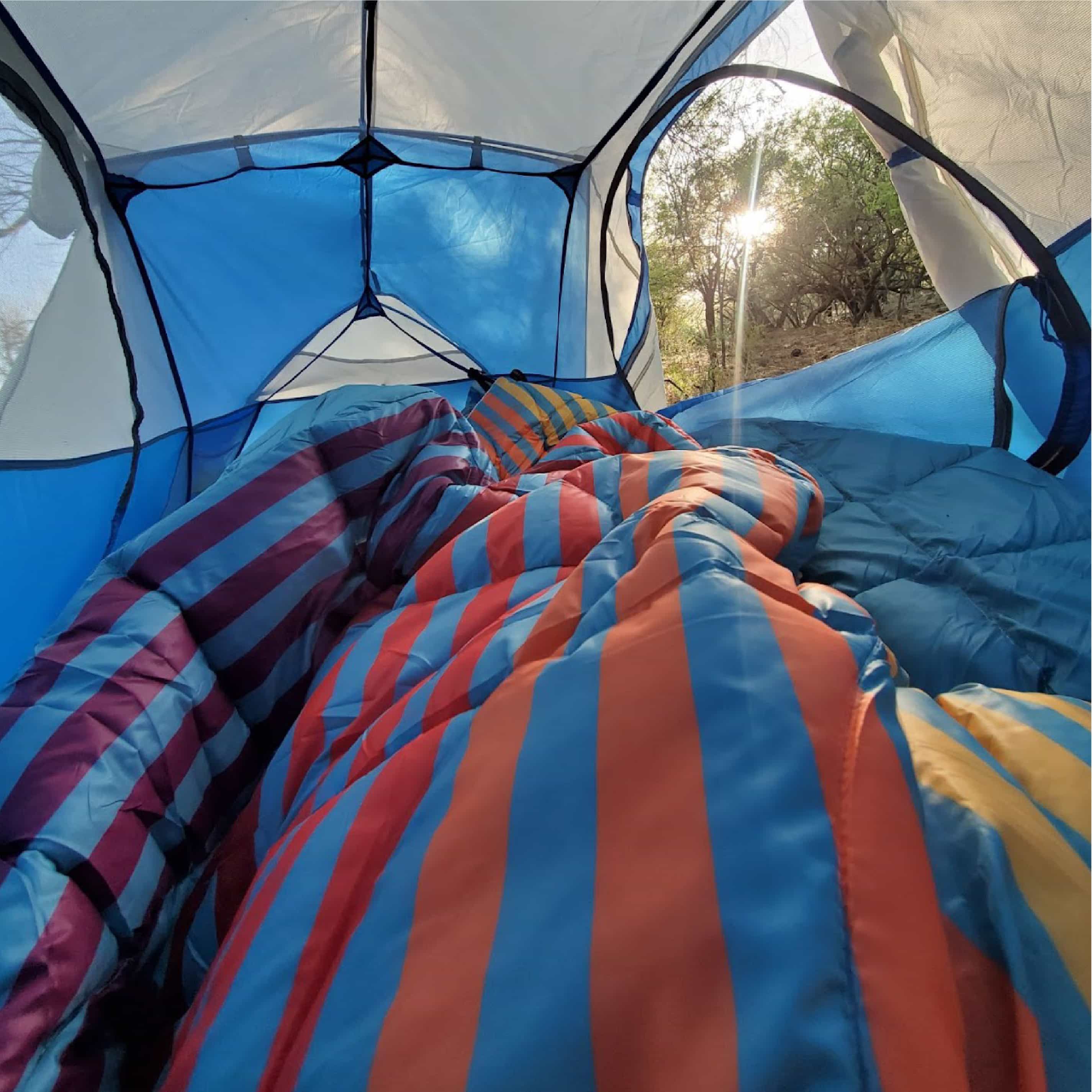 Person Laying In Tent With NanoLoft Puffy Blanket On Them