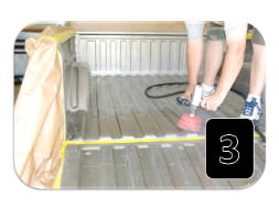 technician prepping truck bed for spray on bedliner 