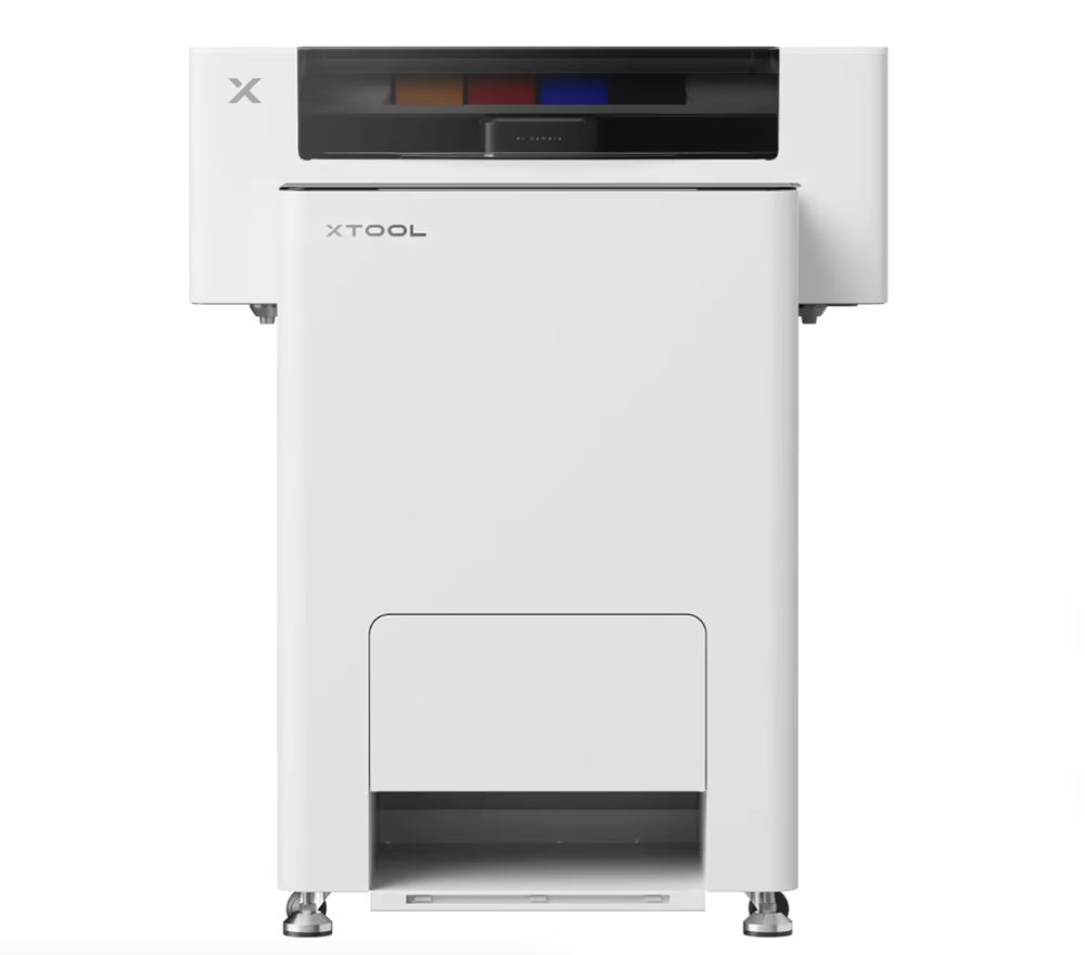 White printer with color cartridges on top and a paper tray at the bottom.