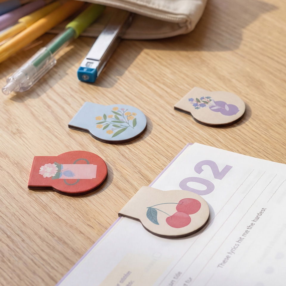 Colorful sticky notes on a wooden table with stationery items.