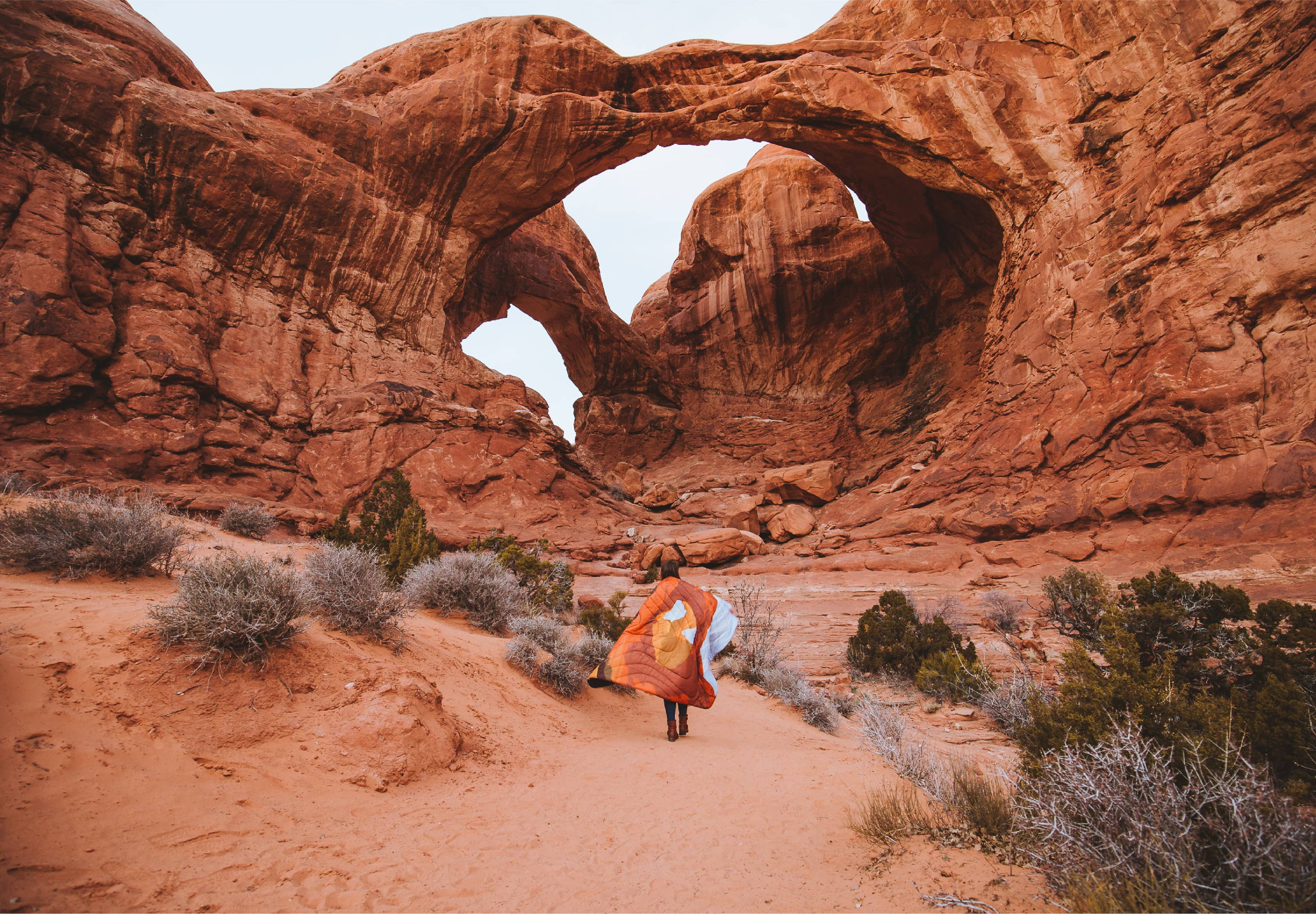 Standing with blanket infront of Delicate Arch