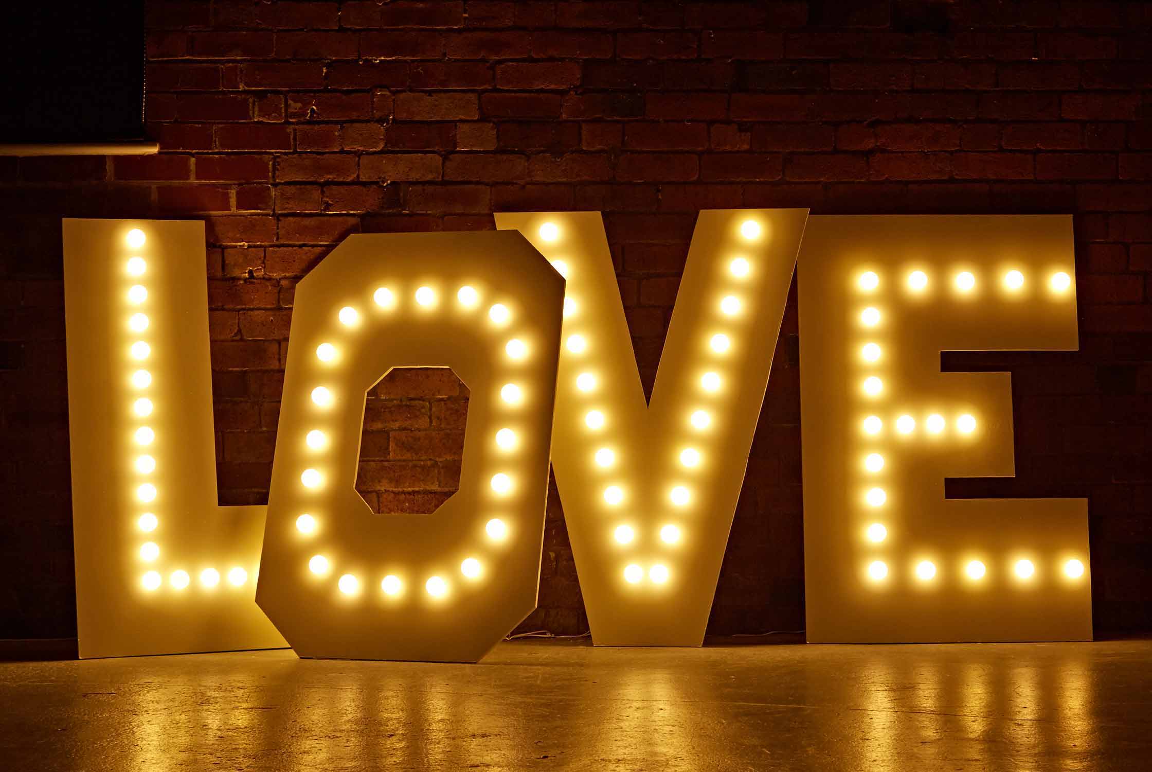 Marquee light letters spelling the word 'love' and illuminated