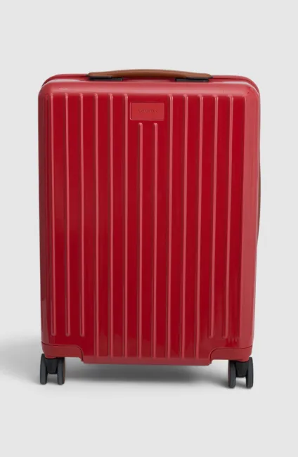Red suitcase with vertical stripes and wheels, viewed from the front.