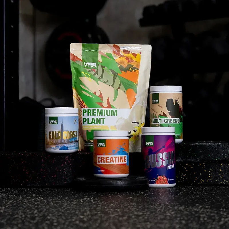 Assorted fitness supplements arranged on a gym floor.