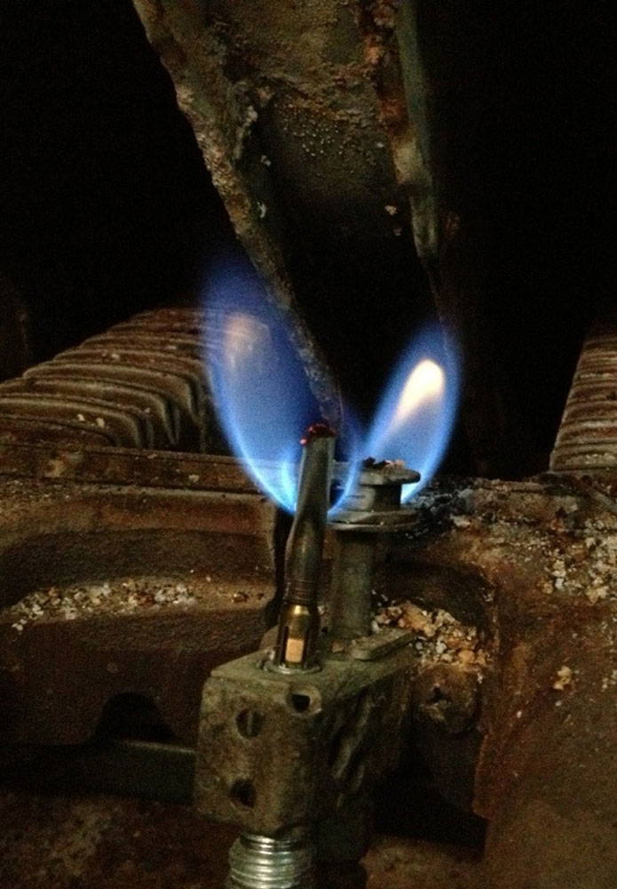 closeup of pilot light in gas furnace
