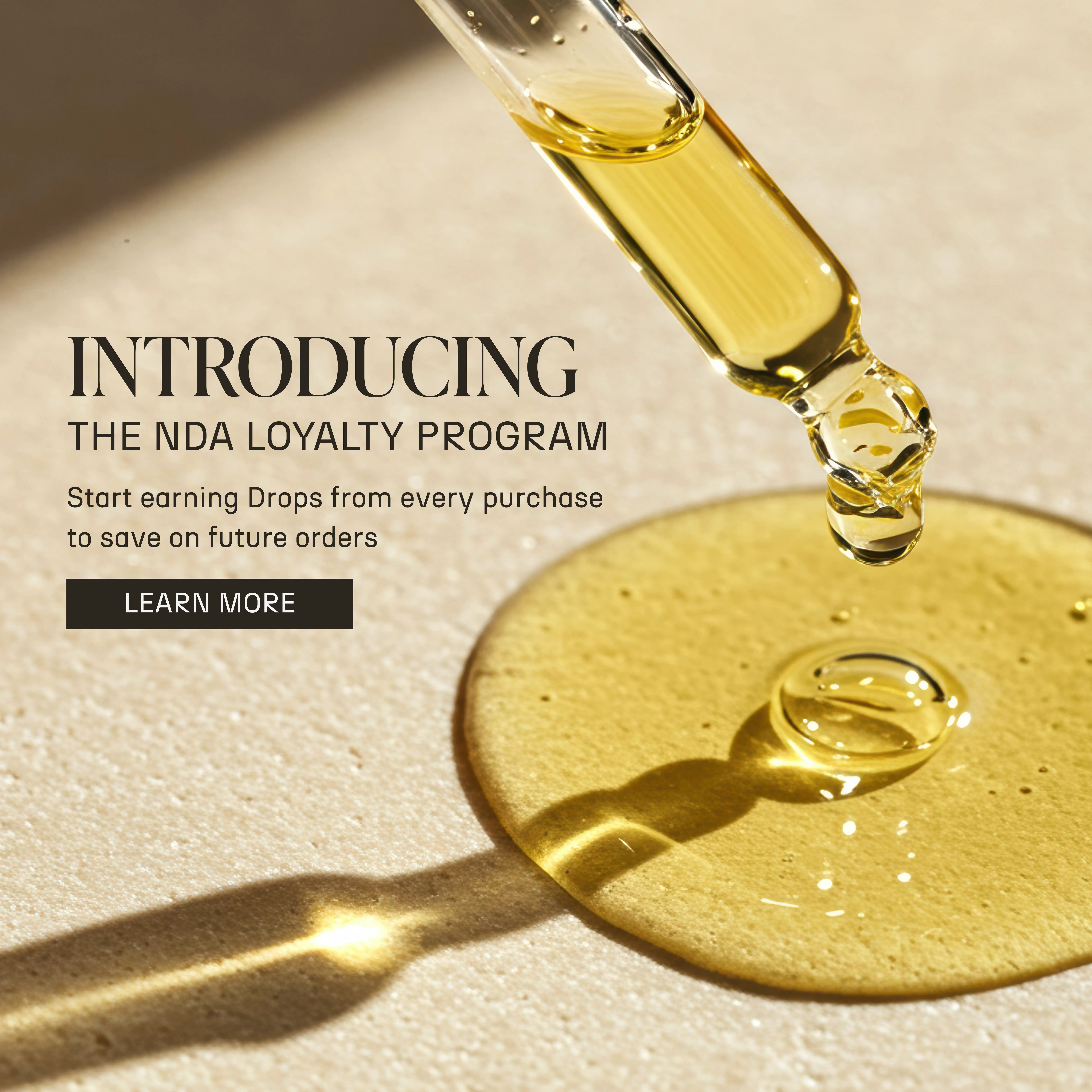 Dropper releasing oil onto a surface, promoting a loyalty program.