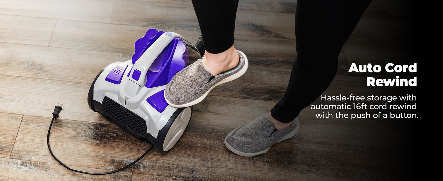 Foot pressing on a vacuum cleaner with auto cord rewind feature.