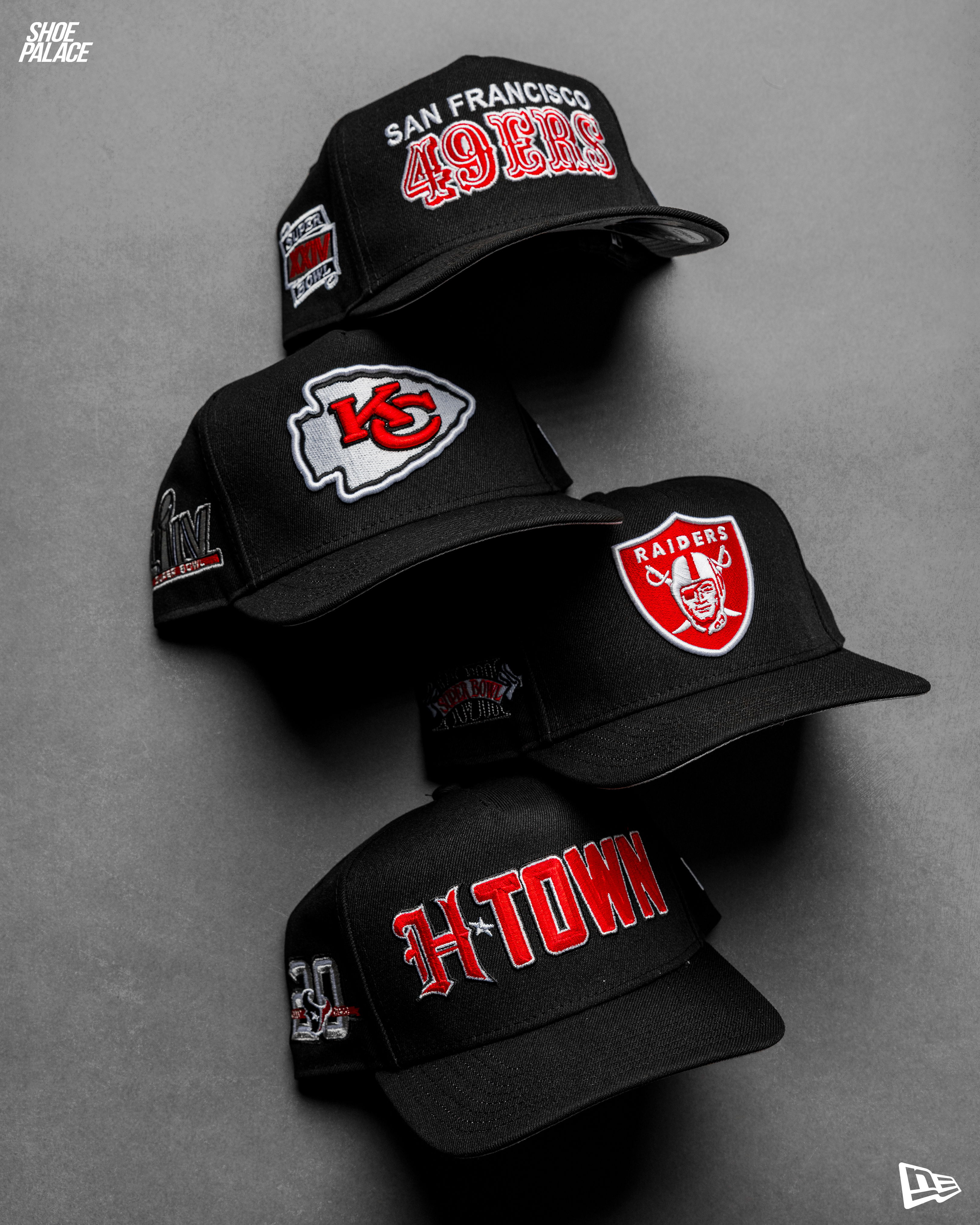 A stack of three football team caps on a gray background.