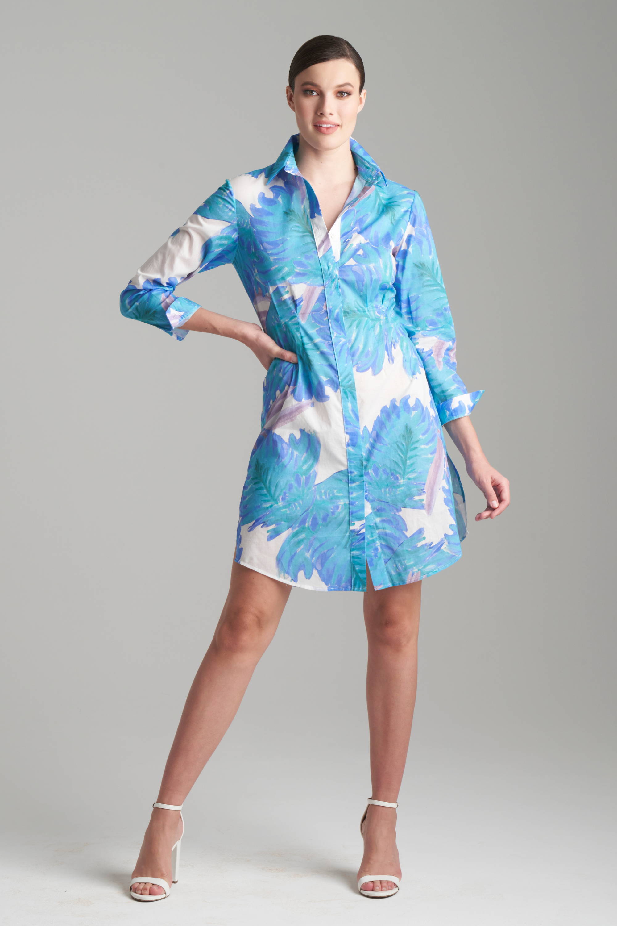 Woman wearing blue palm leaf printed short cotton dress for women's tropical clothing
