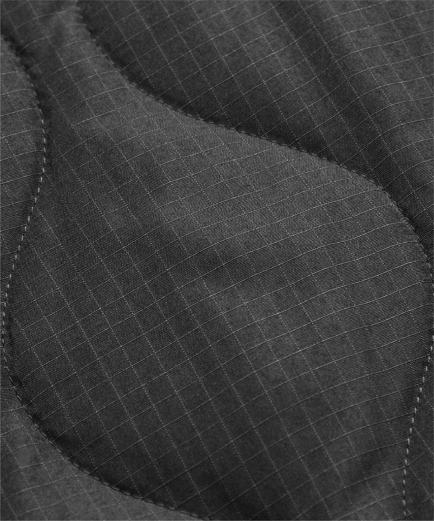 Close-up of textured, dark fabric with curved patterns and pinstripes.