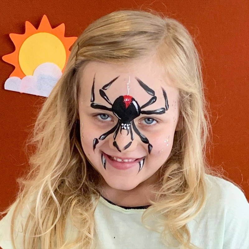 spider face paint on nose, girl