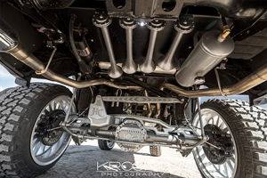 Rear undercarriage shot of train horns and air tank with custom suspension on a lifted Dodge Ram 1500