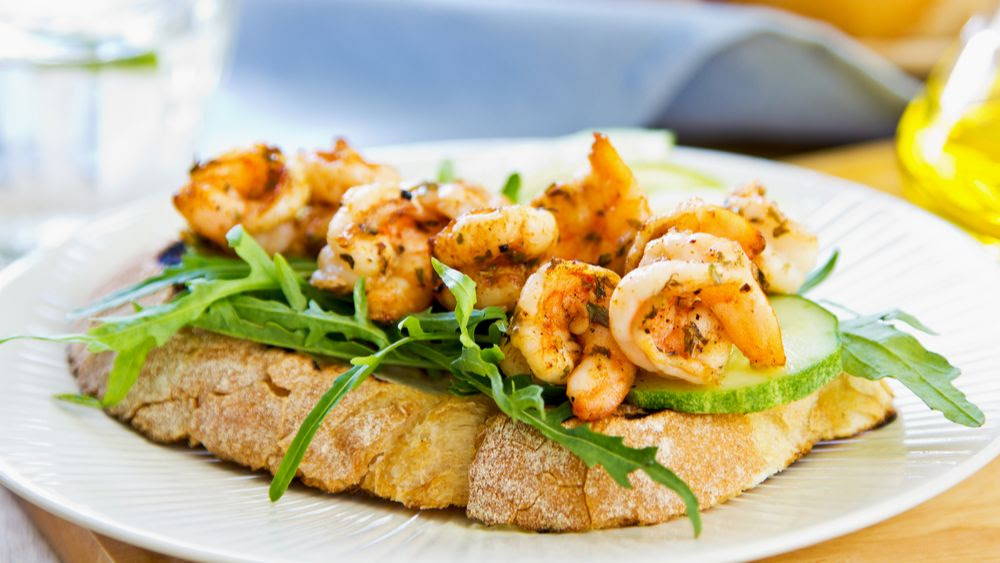 shrimp on toast with arugula and cucumber