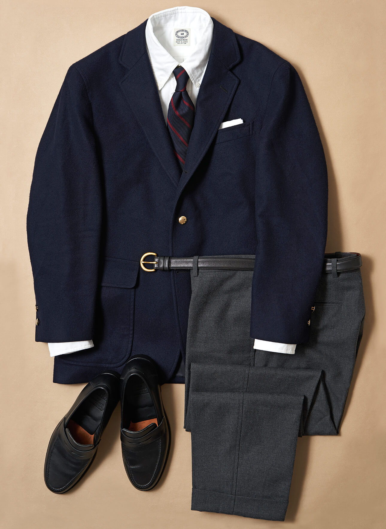 Navy suit jacket, dress shirt, tie, gray trousers, and black shoes.