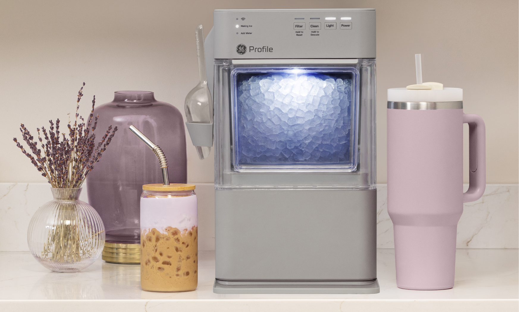 A drink dispenser with various containers and decorative items beside it.