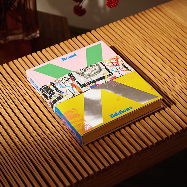 Colorful book resting on a wooden surface with decorative elements in the background.