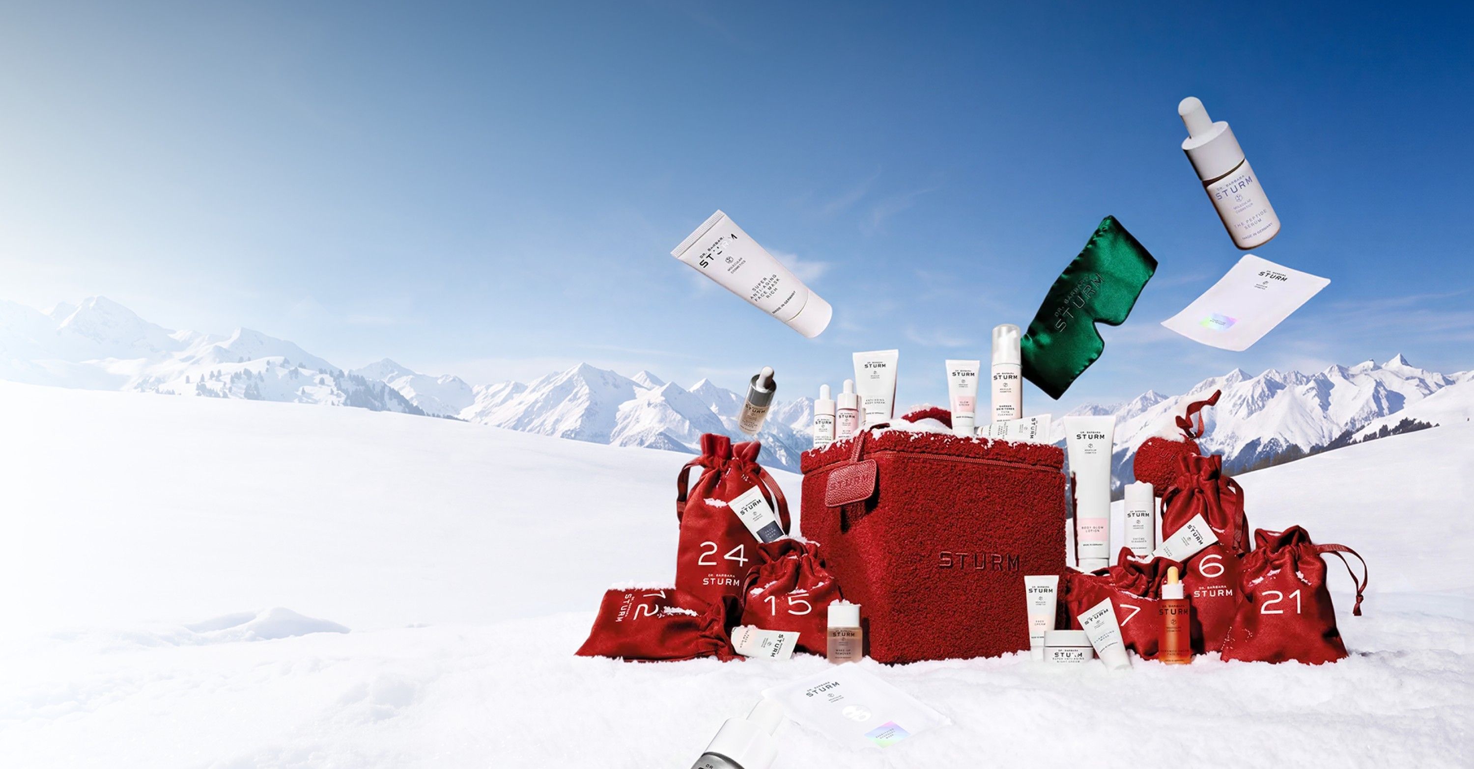 Red gift boxes and various items scattered in snowy mountains.