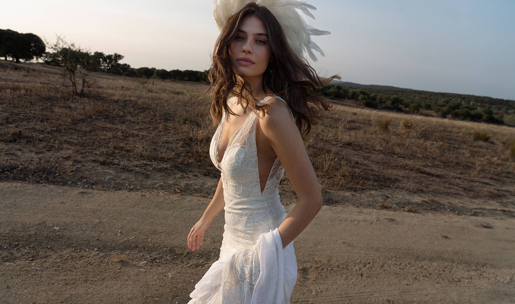 Model wearing the Dahlia gown and feathered head piece on location shoot in Portgual