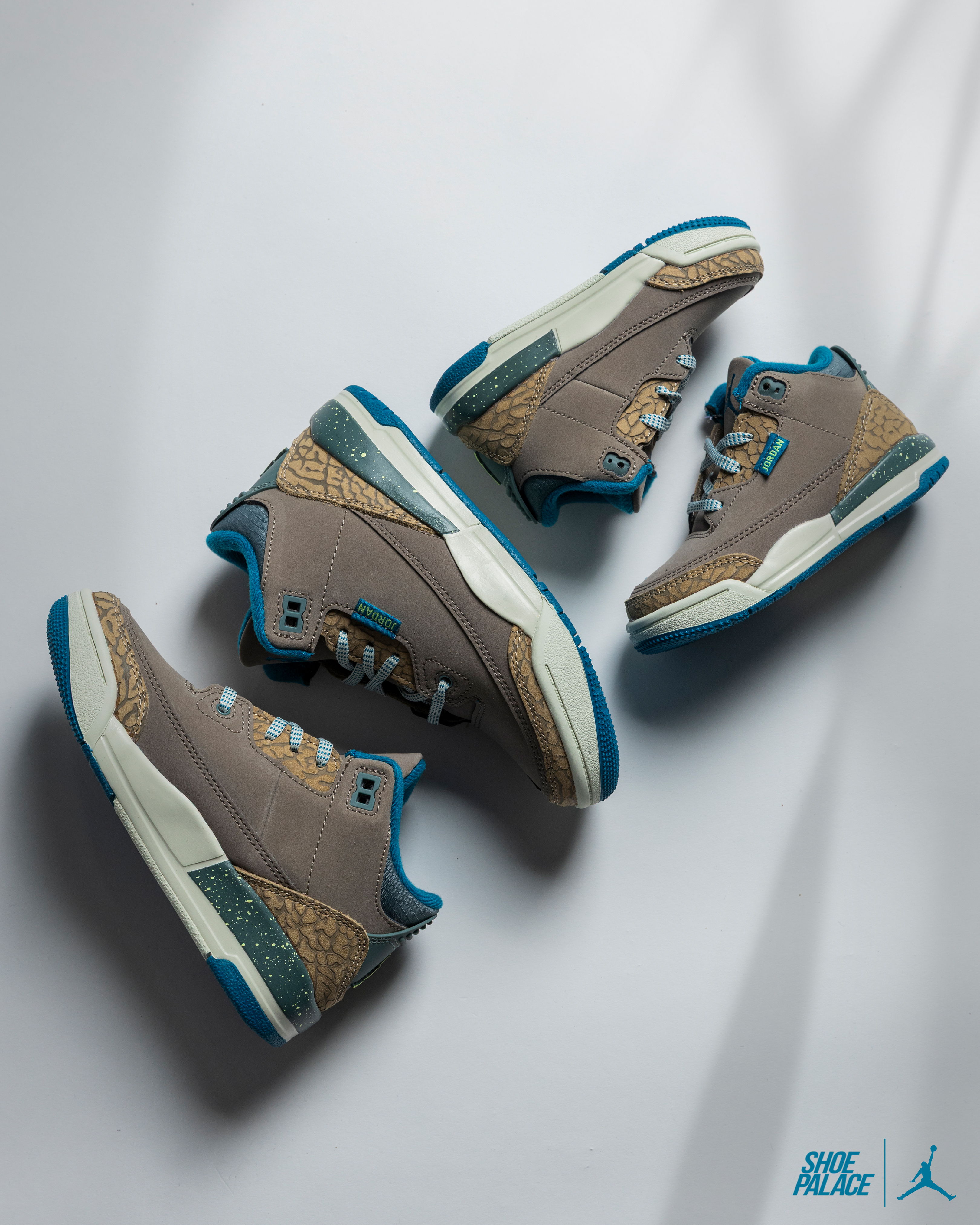 Air Jordan 3 Retro Olive Grey - A pair of gray and blue Nike Jordan sneakers.