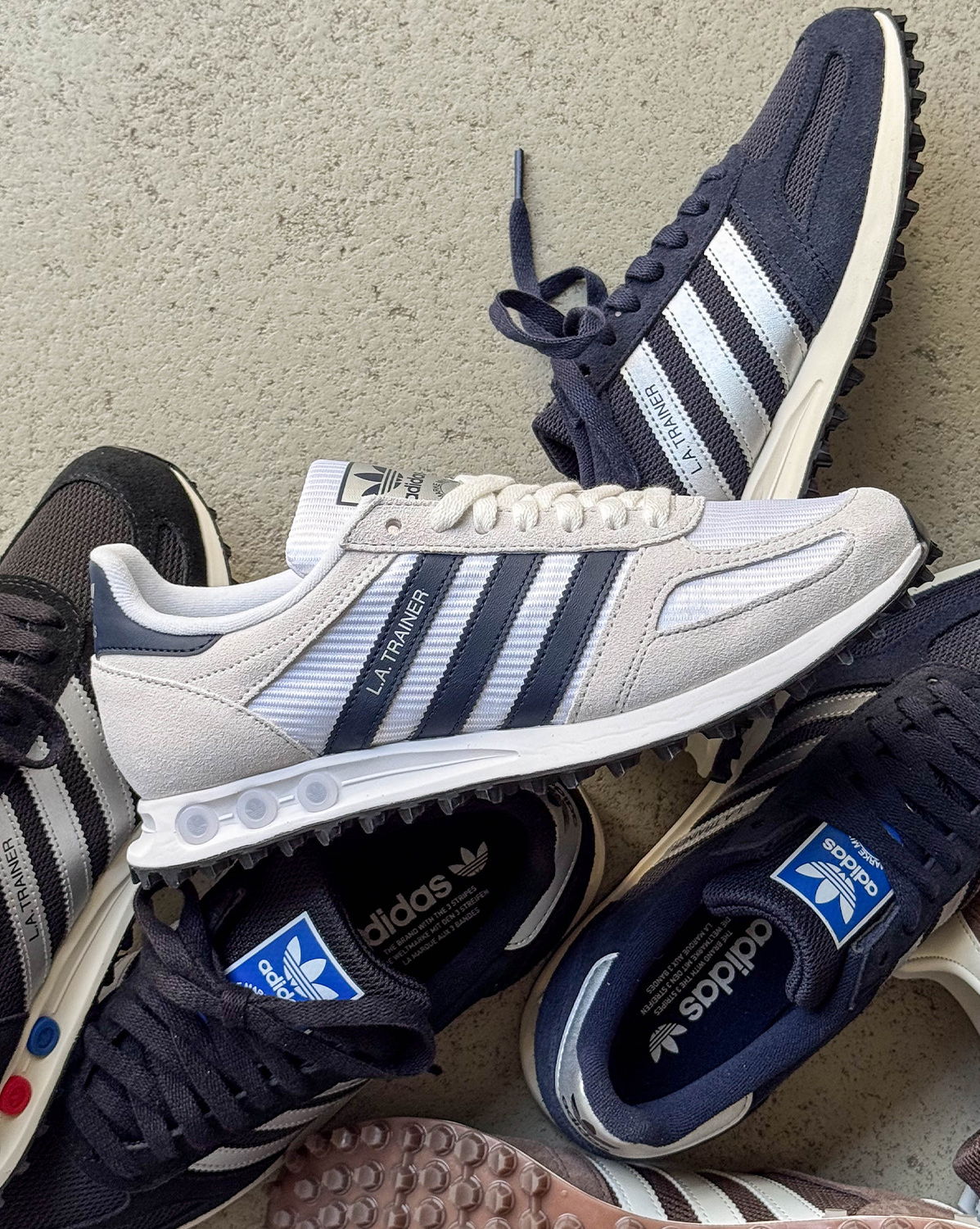 A collection of Adidas sneakers in various colors and styles.