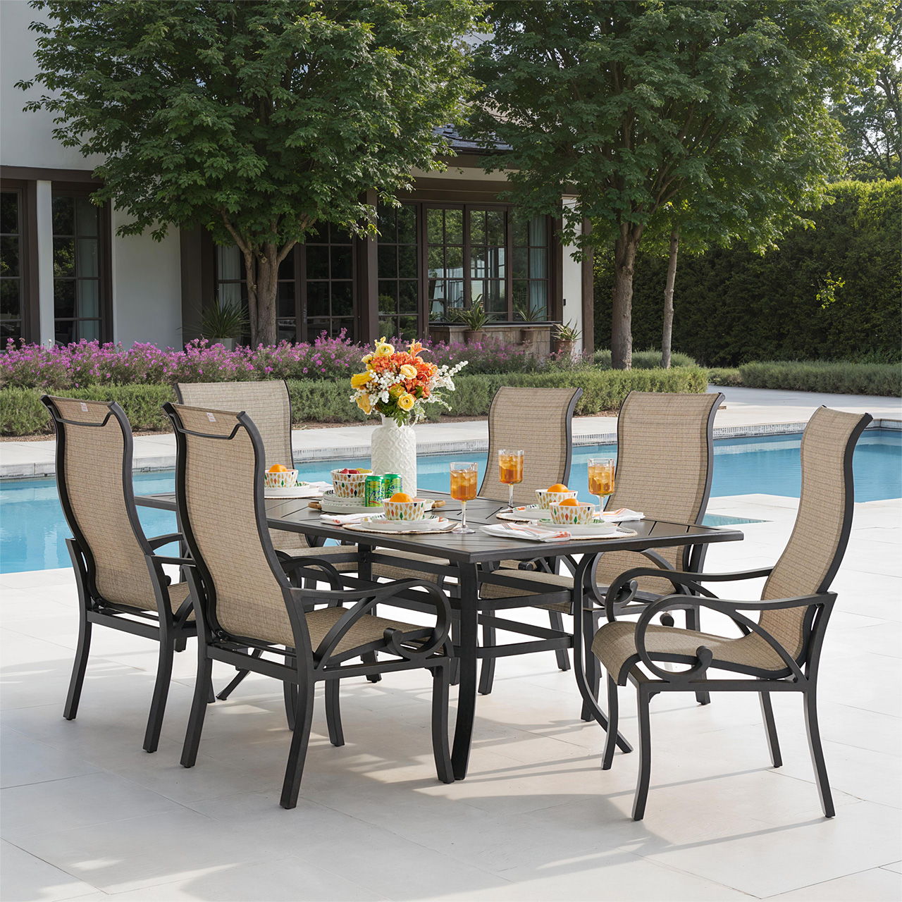 Outdoor dining set with six chairs and a table by a pool.