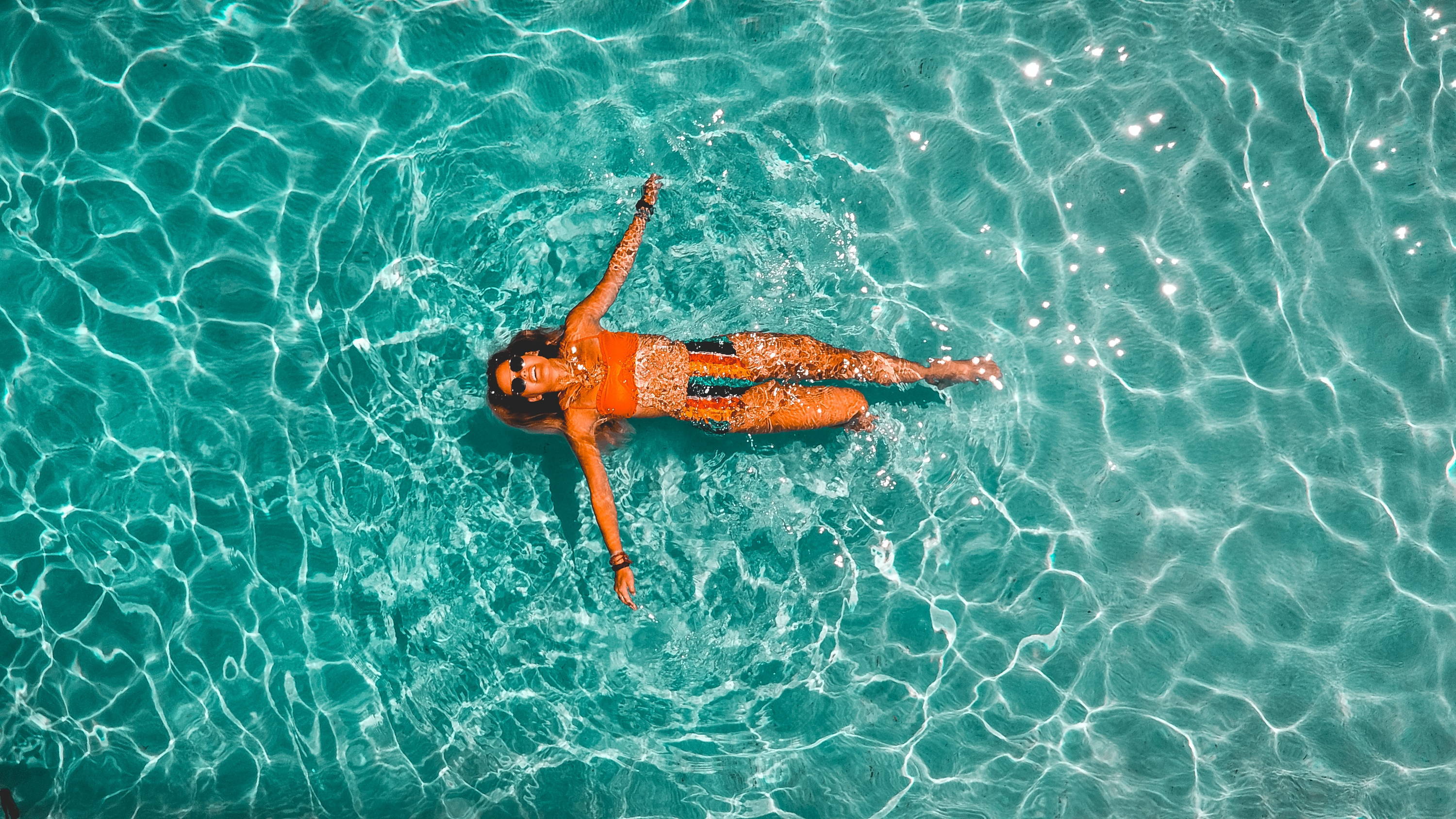 Woman swimming alone in body of water. Photo by Drew Dau on Unsplash