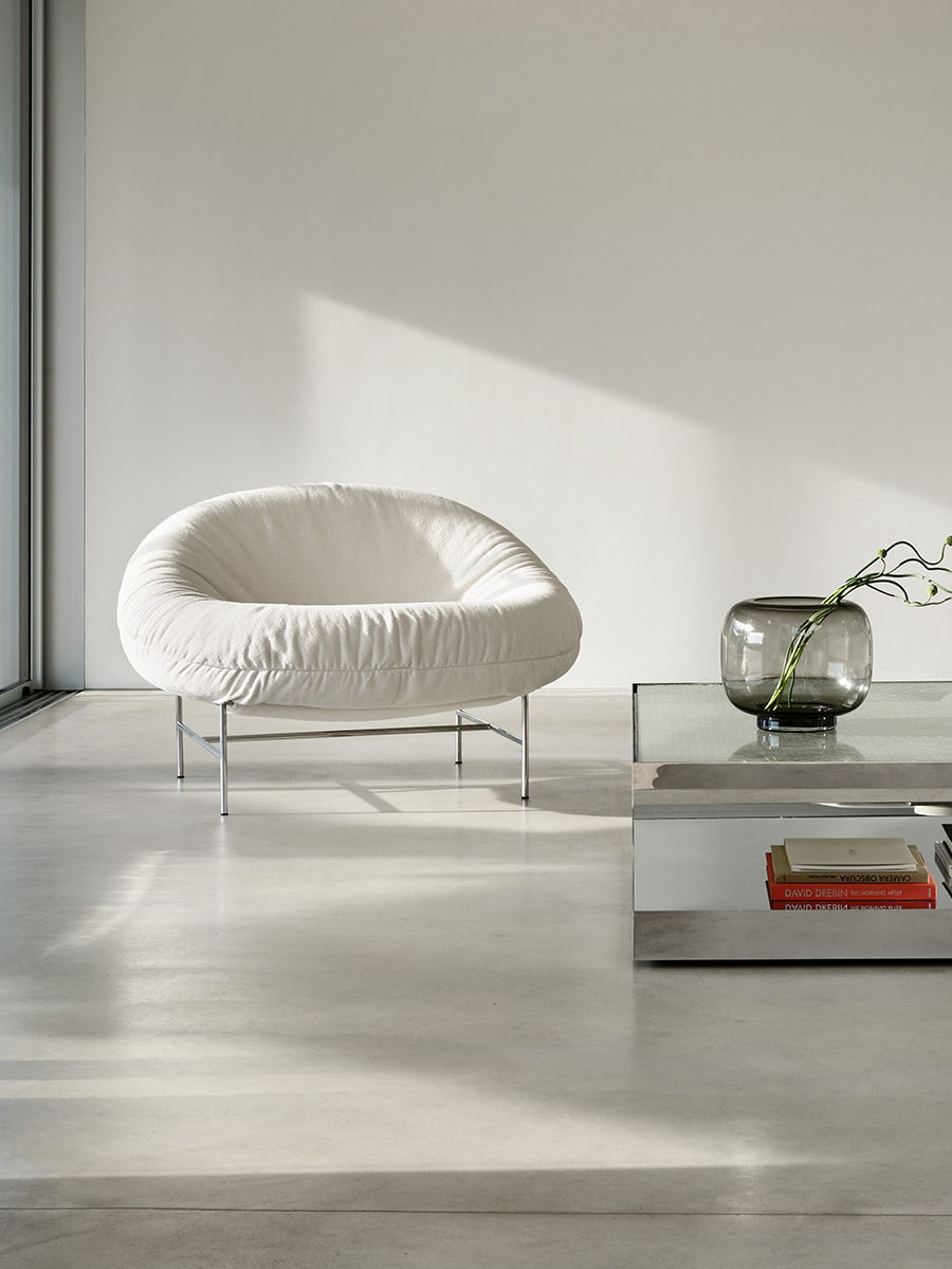 Perron Bun Lounge Chairs by Knoll with soft cushions and metal legs in a minimalist setting.