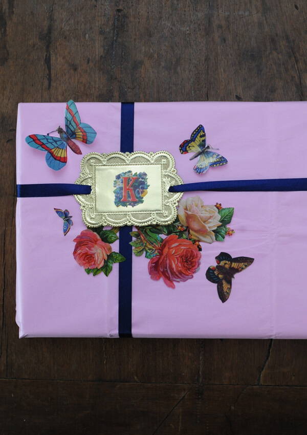 A wrapped Mother's Day gift using The Hambledon satin ribbon in navy,  Rico Design rose pink tissue paper and decoupage paper trims.