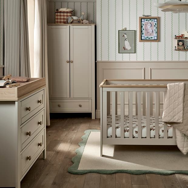 Cozy nursery with a crib, dresser, and soft rug.