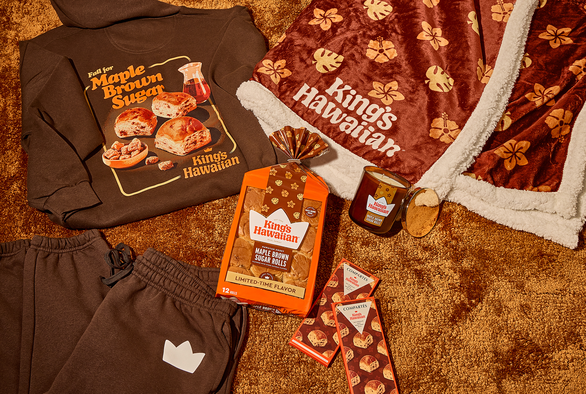 Cozy items including a hoodie, blanket, snacks, and hot chocolate mix.