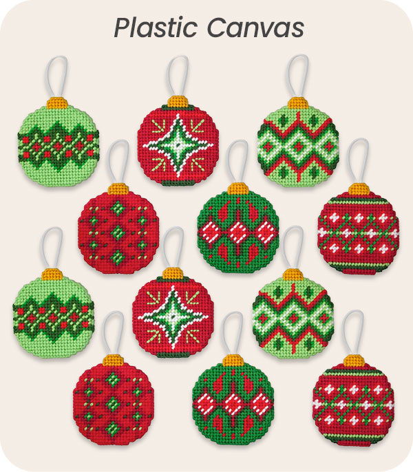 Colorful holiday ornaments on a plastic canvas background.