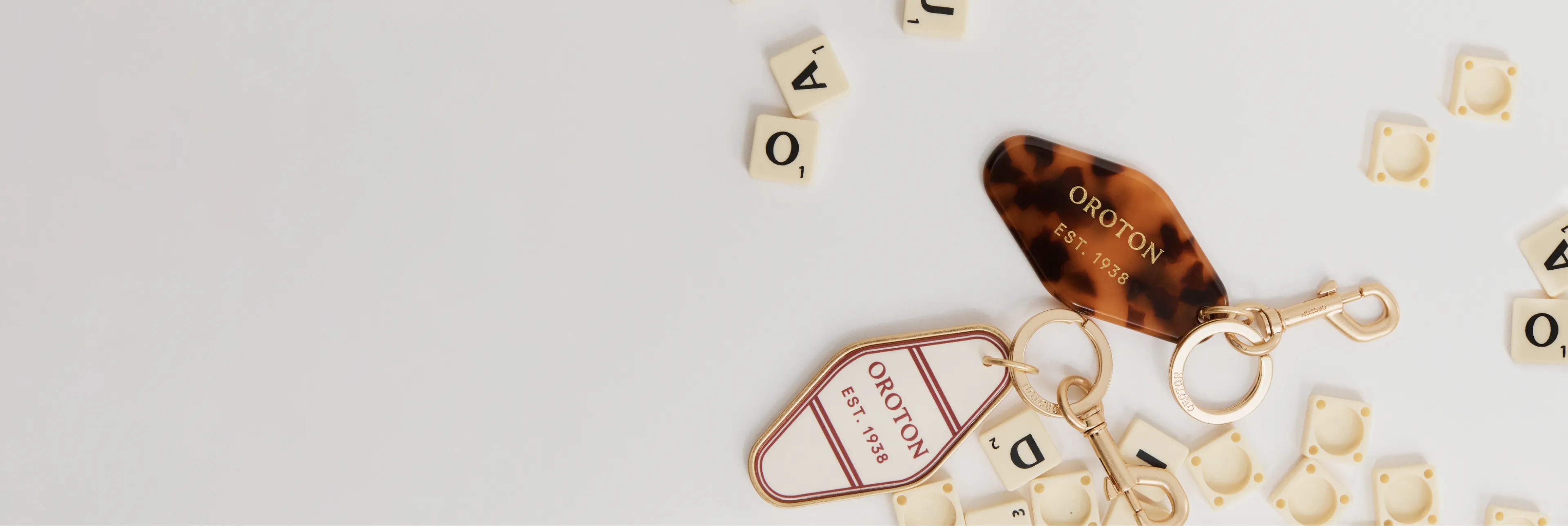 Keys and letter tiles scattered on a white surface.
