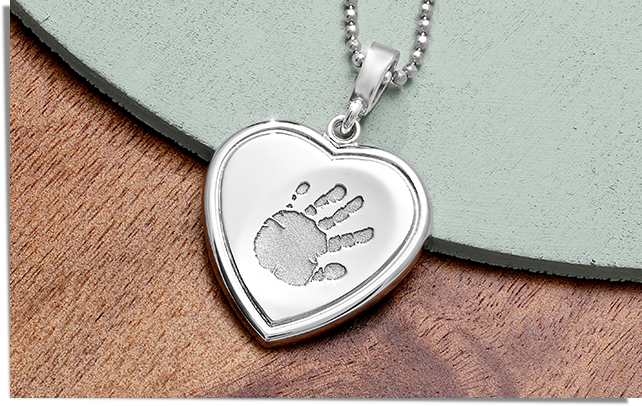 sterling silver heart shaped necklace engraved with a handprint