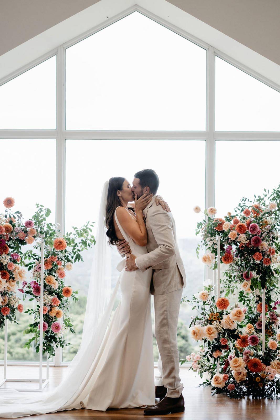 Bride and groom sharing a kiss at wedding ceremony