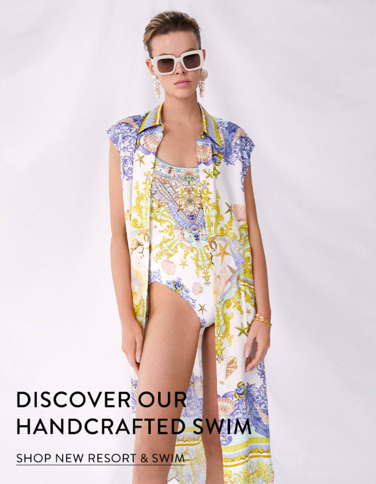 CAMILLA. Discover our handcrafted swim. Model wearing Star of the Sea printed resort and swimwear