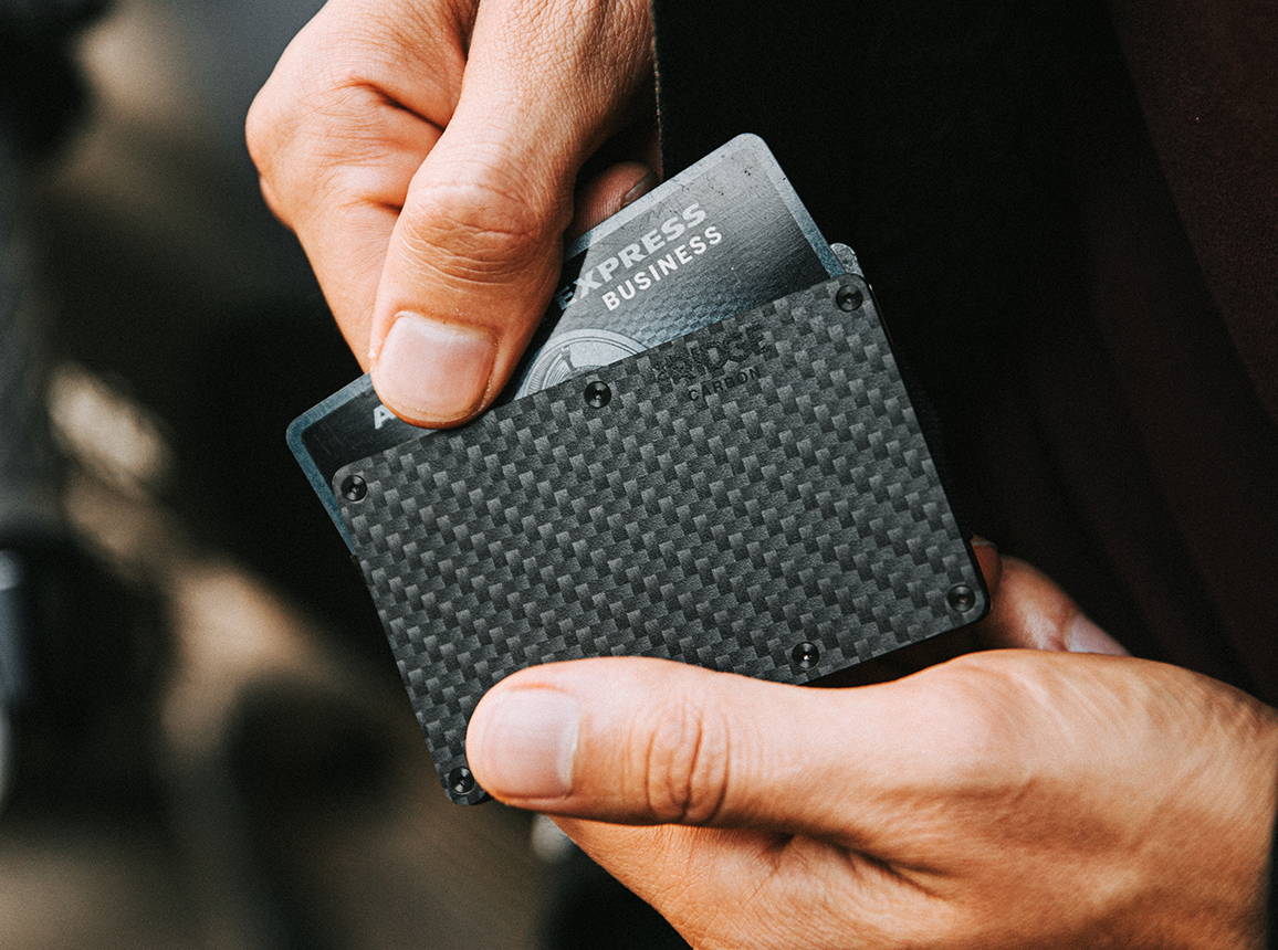 man pulling card inside carbon fiber Ridge wallet