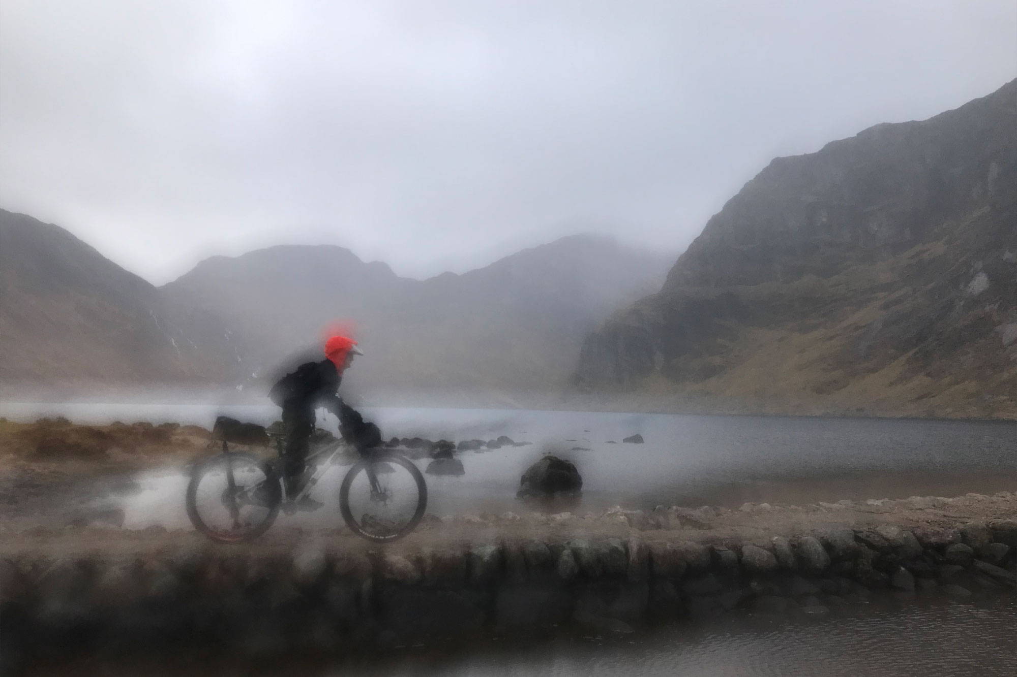 Rainy photo of Rich riding the Fisherfield causeway