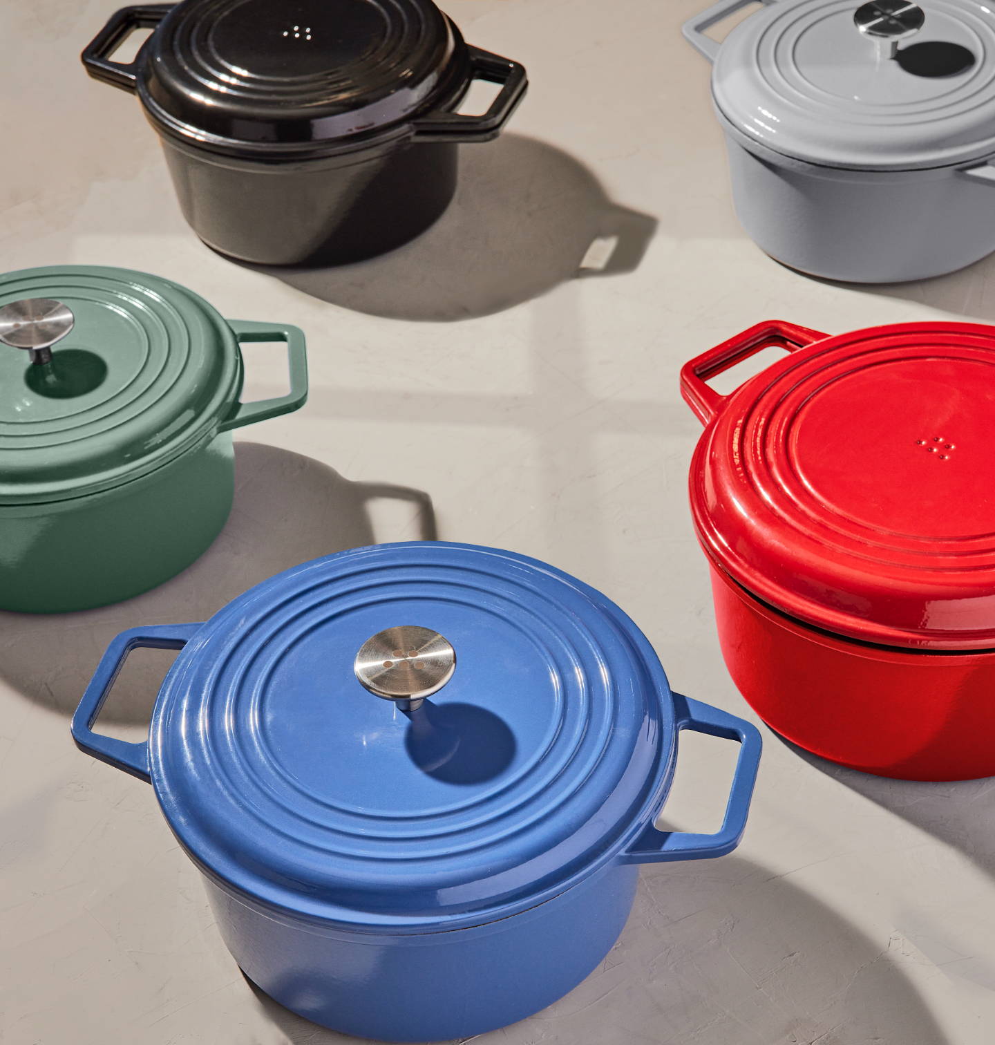 Covered Blue, Green, and Gray Misen Dutch Ovens with Traditional Lid, with Black and Red Misen Dutch Ovens with Grill Lid visible.