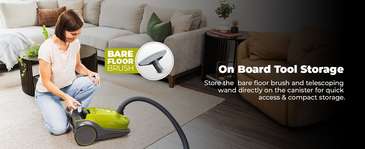Woman using a vacuum cleaner with onboard tool storage in a living room.