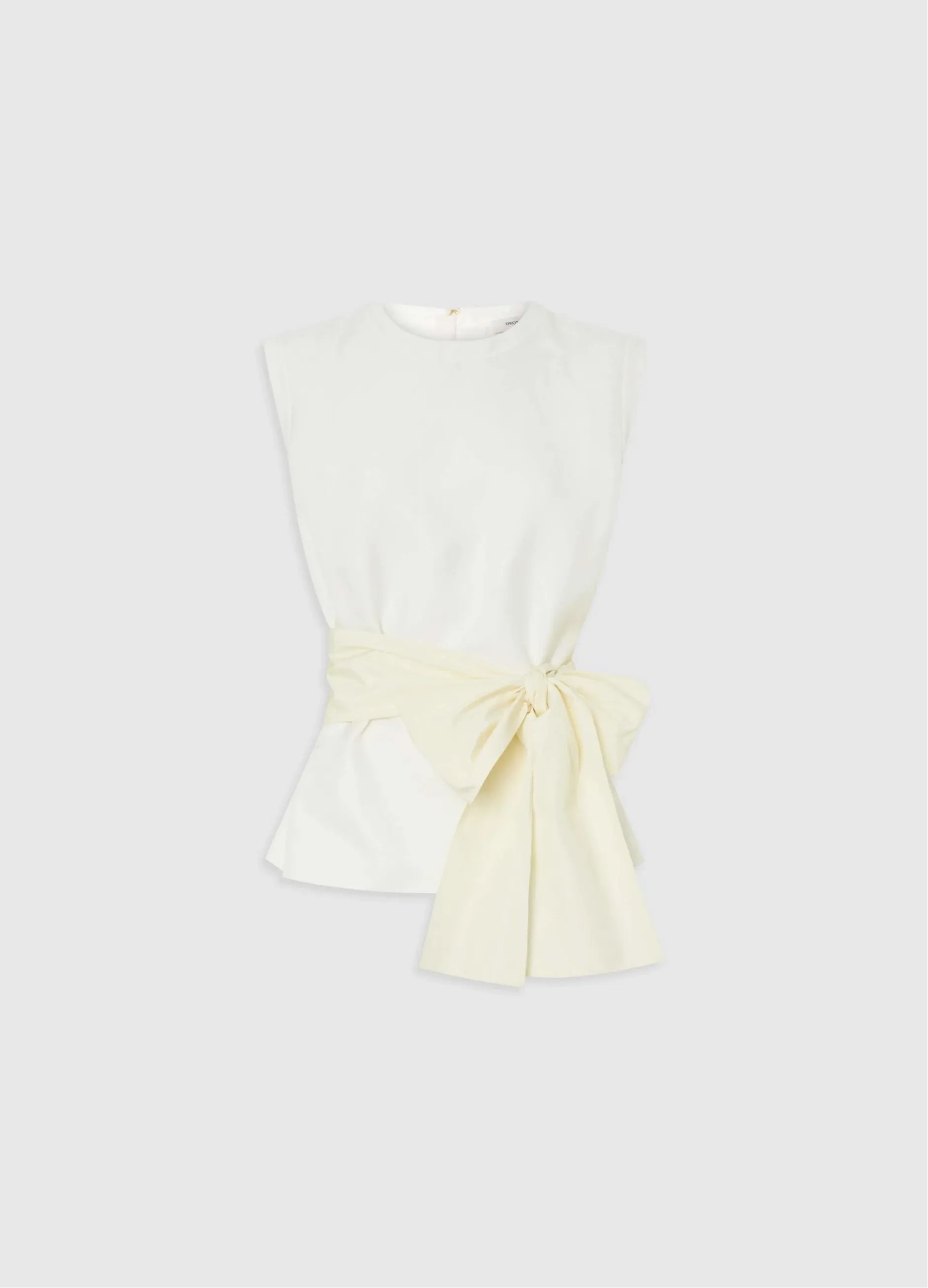 White top with a yellow bow detail at the waist.