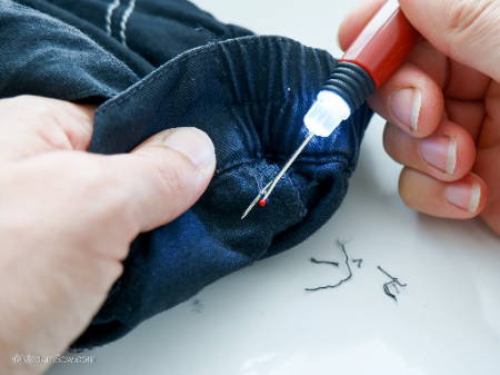 Removing dark stitches with a lighted seam ripper