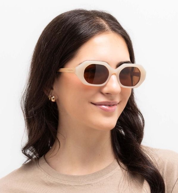 woman wearing Mia Ivory tiny geometric sunglasses on a white background