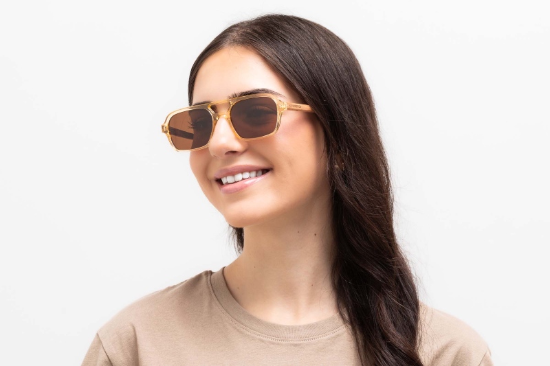 woman wearing Tanner rectangle aviator sunglasses for triangular faces on a white background