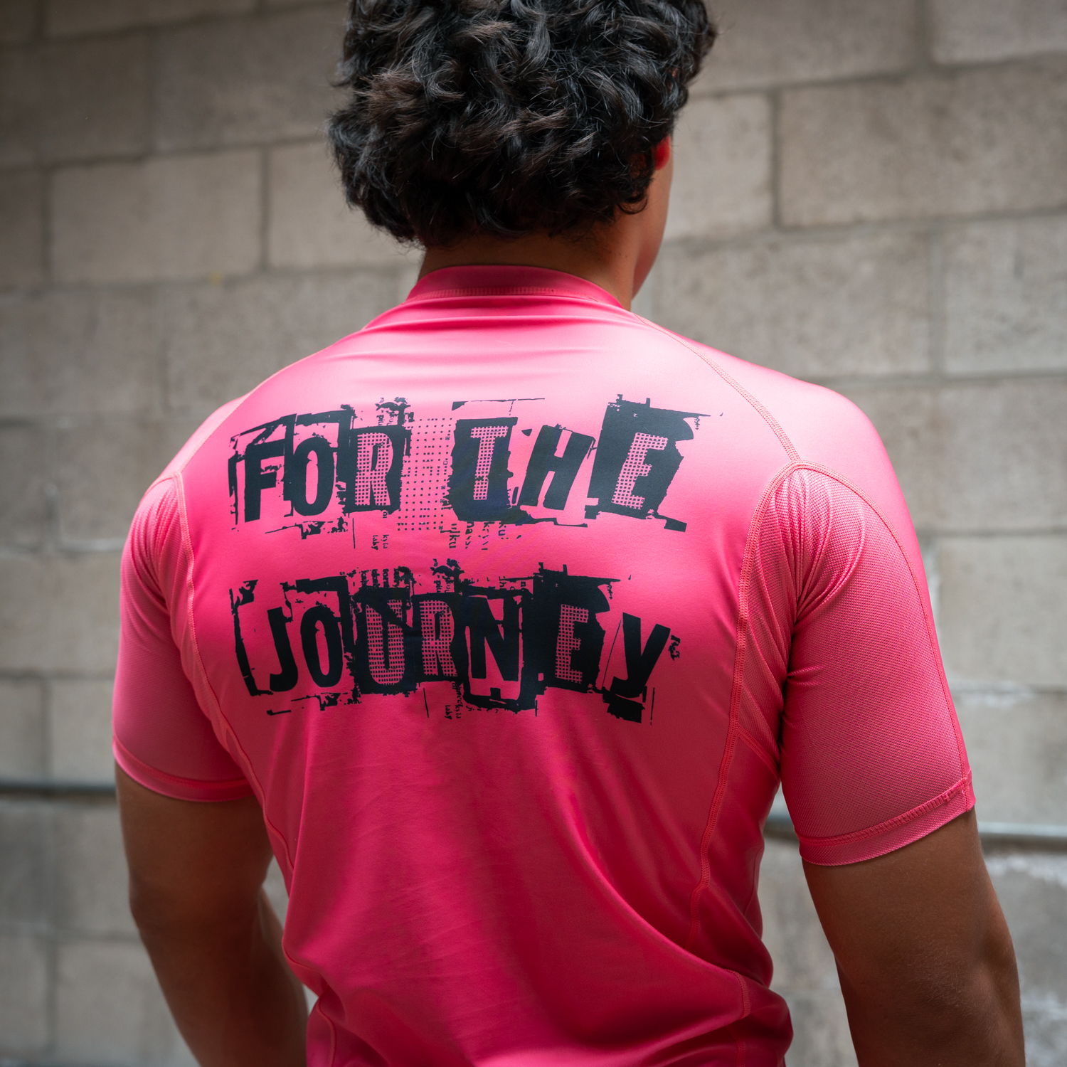 Person wearing a pink shirt with 