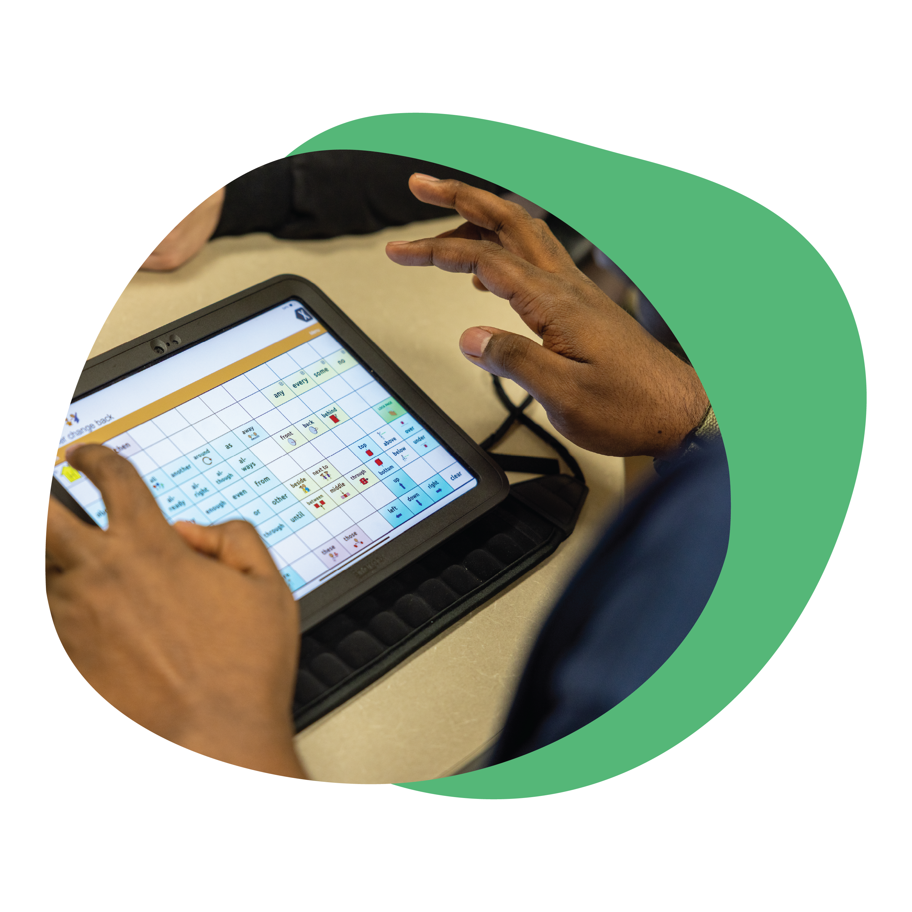 Person using a tablet with an AAC device, focused on the screen.