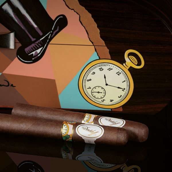 The Davidoff & Boyarde Masterpiece Humidor Geometrically Speaking with two toro cigars placed in front of it. 