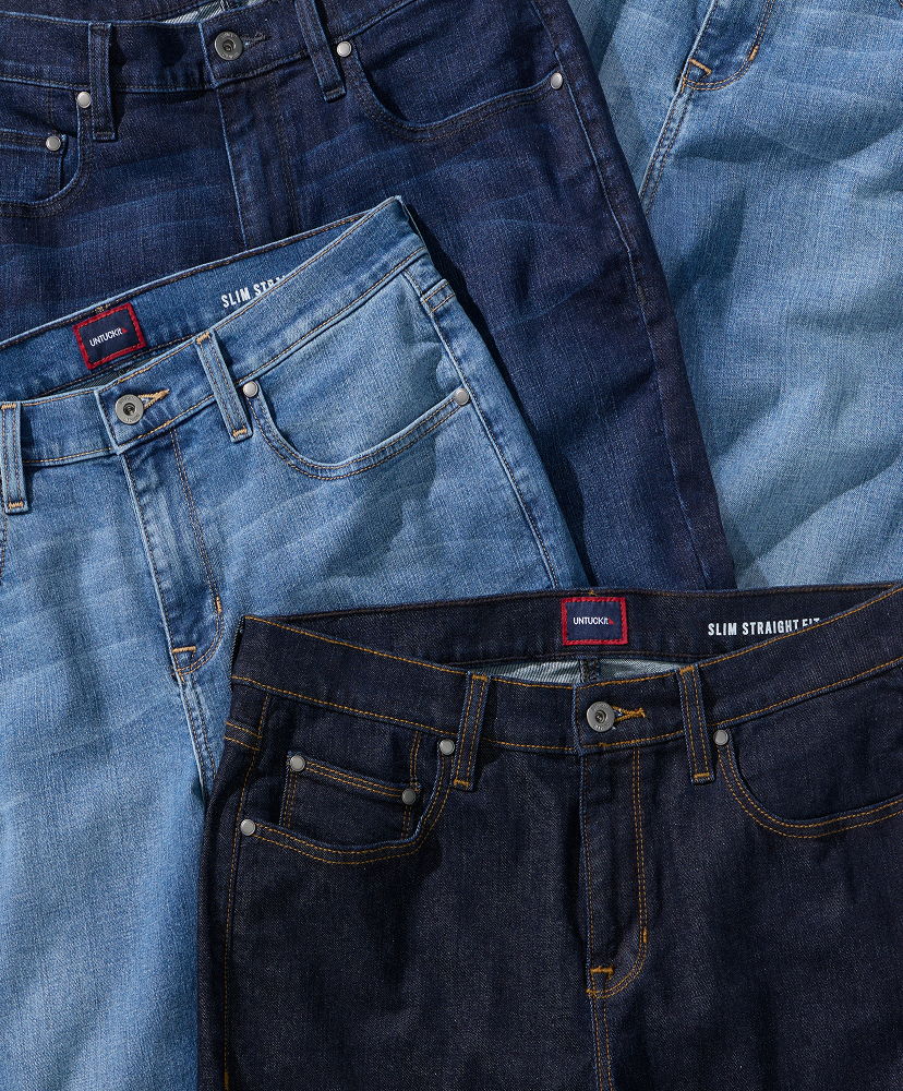 Three pairs of jeans in varying shades of blue arranged together.